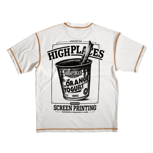 White t-shirt with orange overlock contrast stitching and a graphic print of an orange yogurt cup on the front, along with the text 'HIGH PLACES SCREEN PRINTING: Handcrafted in Vancouver B.C. Canada'